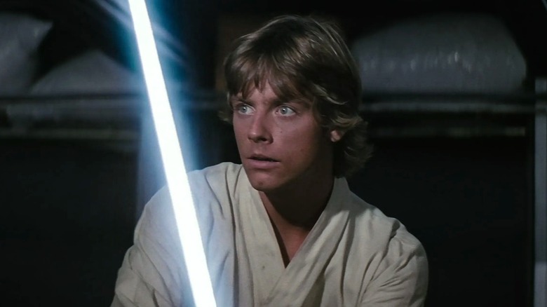 Luke Skywalker wielding a lightsaber in Star Wars: Episode IV - A New Hope