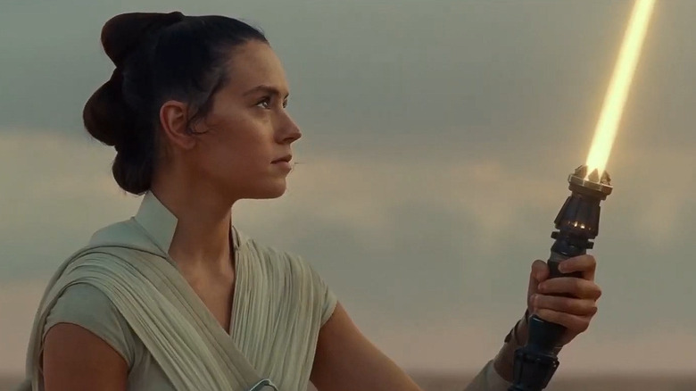 Rey lighting her yellow lightsaber in the final scene of the Skywalker Saga
