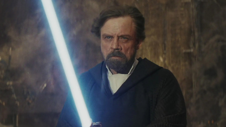 Luke Skywalker holding a lightsaber in Star Wars: Episode VIII - The Last Jedi