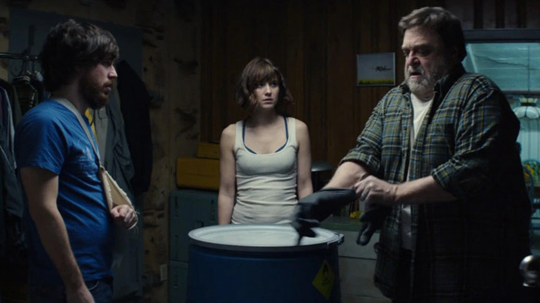 Emmett, Michelle, and Howard gather around a barrel