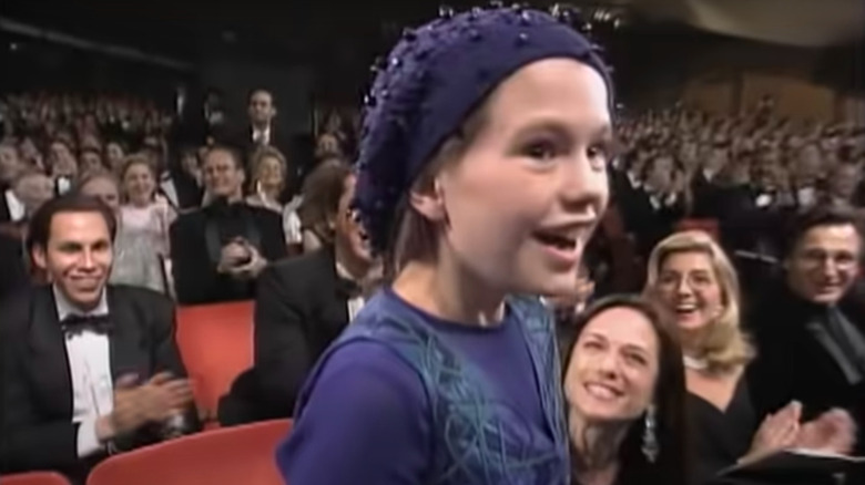 Holly Hunter smiling up at Anna Paquin after her win