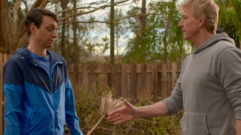 Johnny Lawrence extending his hand to Daniel LaRusso