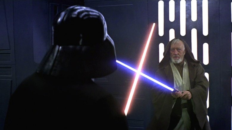 Alec Guiness as Obi-wan Kenobi crossing sabers with Darth Vader