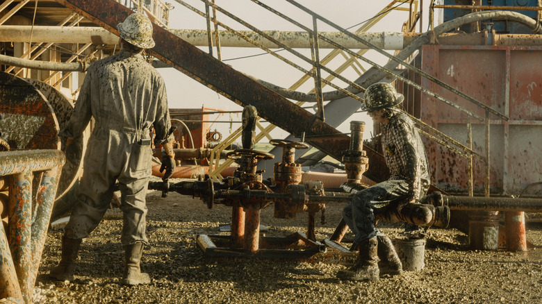 Two men work in the oil field in "Landman"
