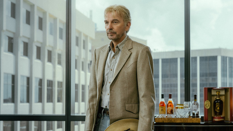 Tommy in front of Cami's boardroom windows in "Landman"