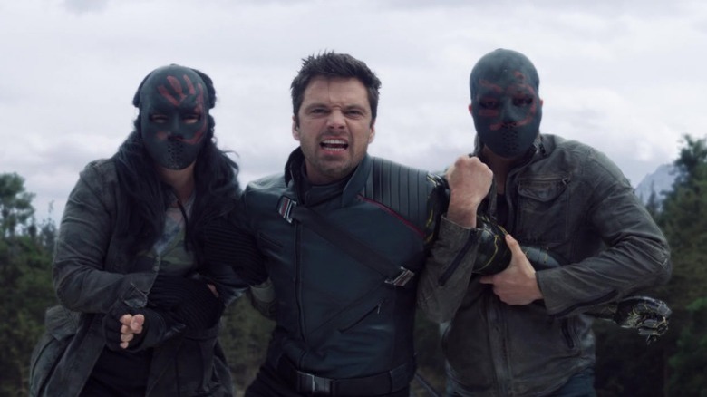 Bucky Barnes restrained by two Flag Smashers