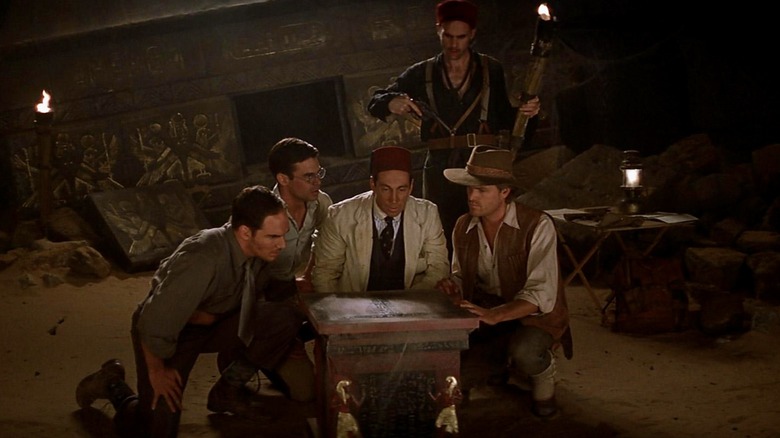 The Americans sit around a chest