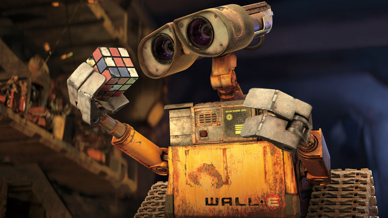 WALL-E looks at a Rubik's cube