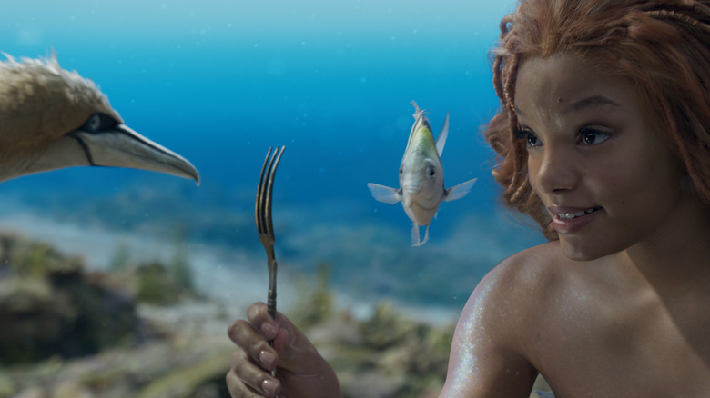 Ariel and her friends looking at a fork