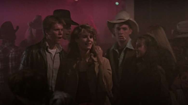 Kevin Bacon as Ren McCormack, ﻿Lori Singer as Ariel Moore, Chris Penn as Willard Hewitt, and Sarah Jessica Parker ﻿as Rusty ﻿in Footloose