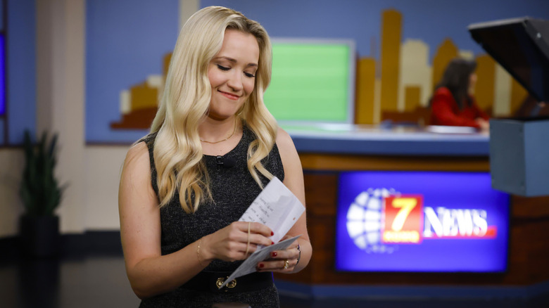 Mandy smugly looks at her notes in "Georgie & Mandy's first marriage"
