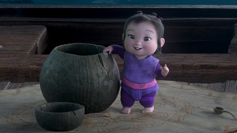 Baby Noi with hand on pot in Raya and the Last Dragon