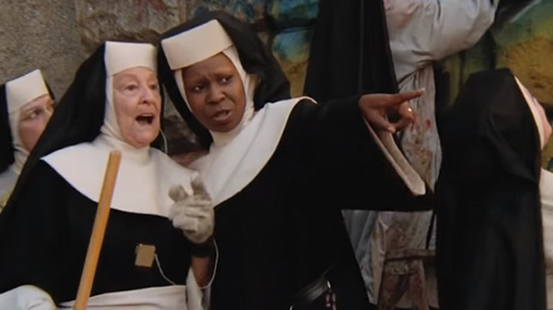 Delores points while nuns paint