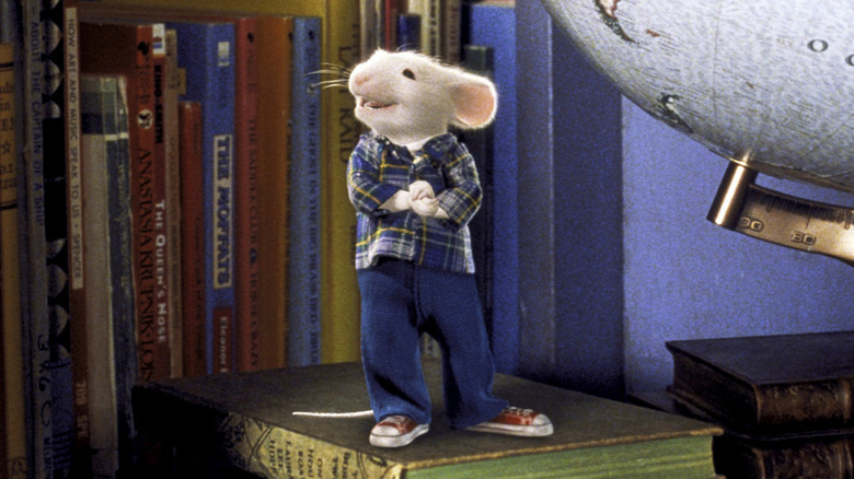 Stuart Little standing on books