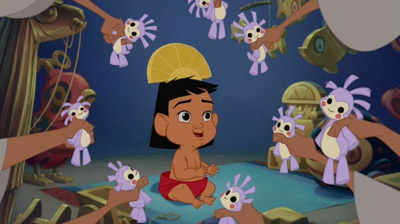 Baby Kuzco being presented with toys