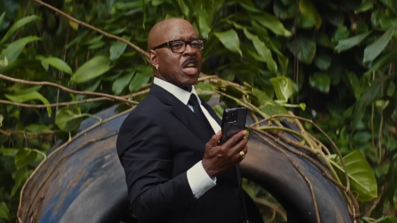 Cobra Bubbles speaks intensely while holding phone