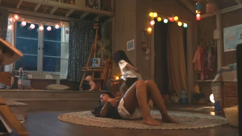 Lilo running through bedroom while Nani is lying on the floor