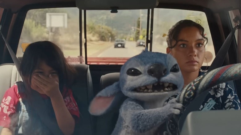 Lilo and Nani sitting in car while Stitch drives