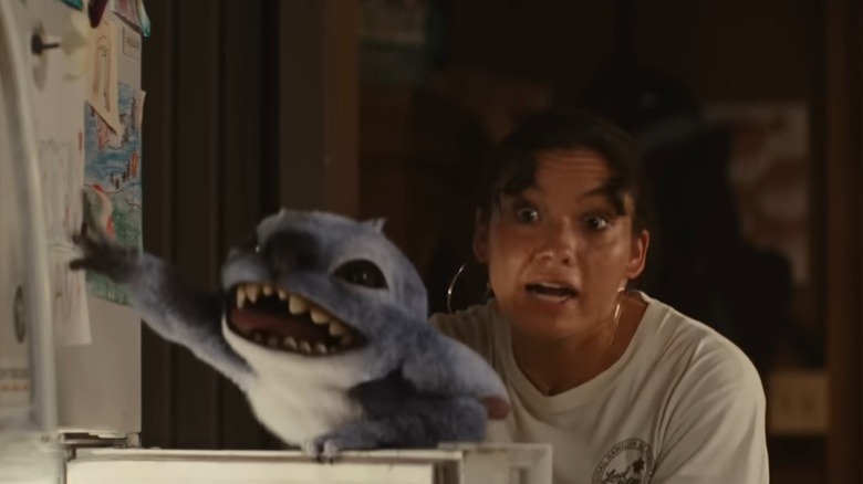 Nani arguing angrily while Stitch goofs around with the refrigerator doors