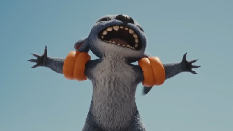 Stitch laughing and opening his arms while wearing arm floaties