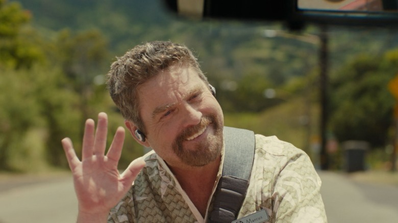 Jumba in human form waving and grinning angrily