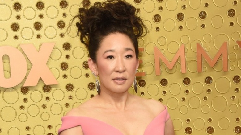 Sandra Oh posing on Emmy red carpet