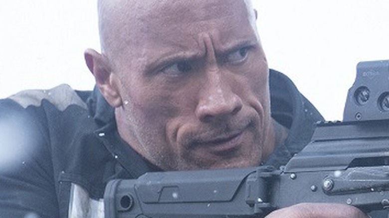 Dwayne Johnson with assault rifle