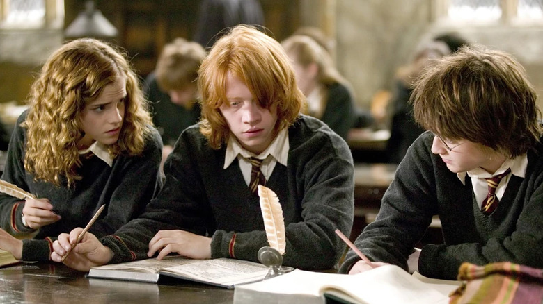 Harry, Ron, and Hermione studying