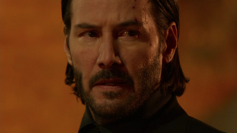 John Wick looking bruised and menacing