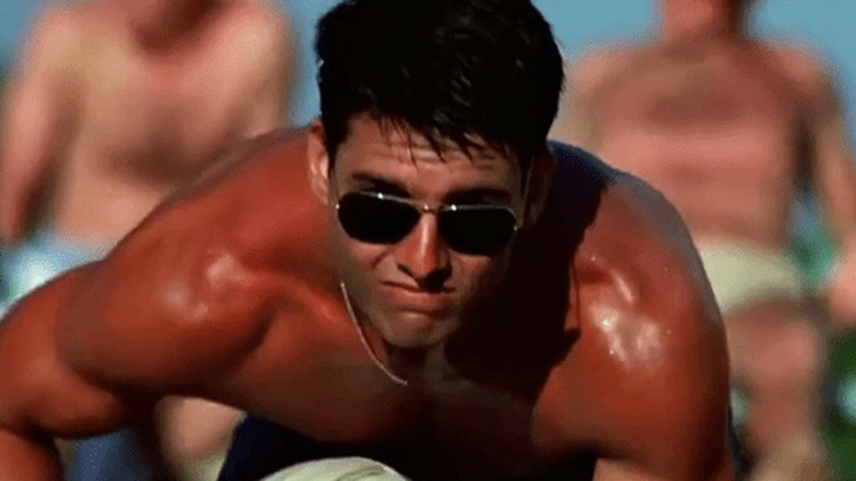 Maverick stands shirtless