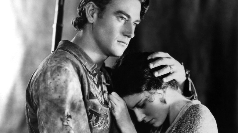 John Wayne comforts Marguerite Churchill 