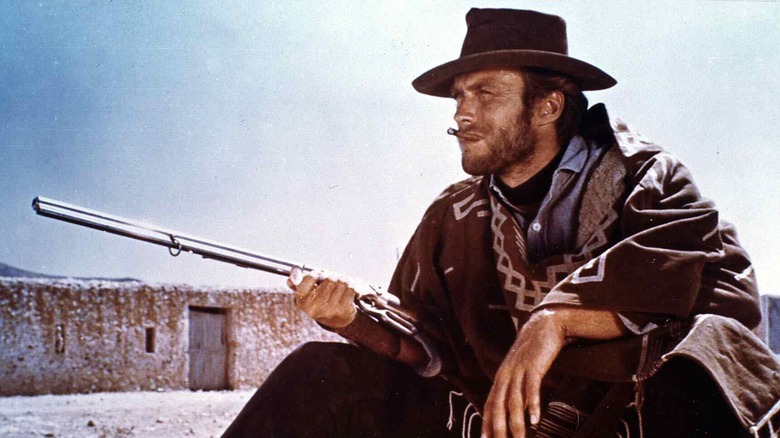Clint Eastwood sits with gun