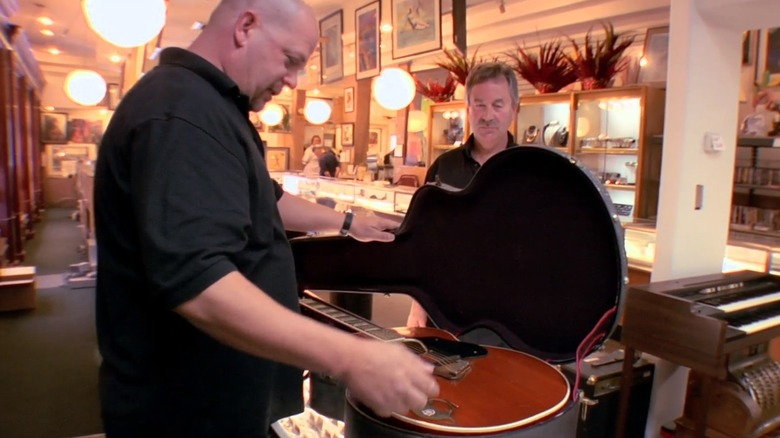 Rick inspects the guitar
