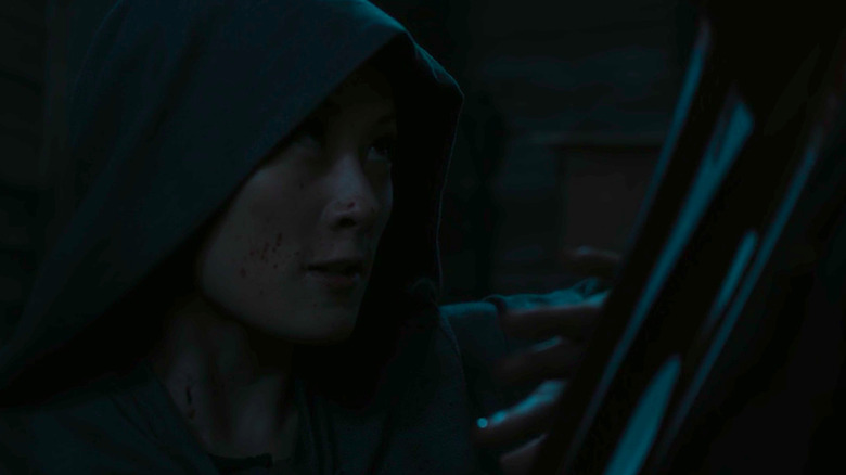 Ah Toy wearing a hood