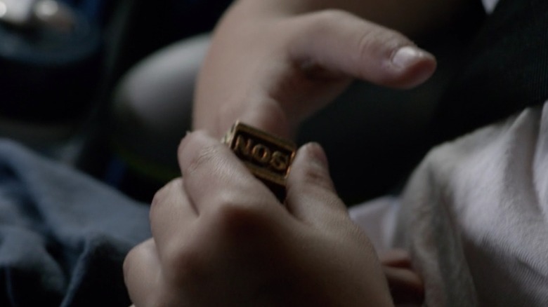 A closeup of Abel holding a SON ring