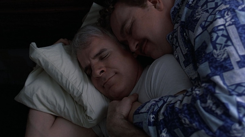 Neal and Del cuddling in bed