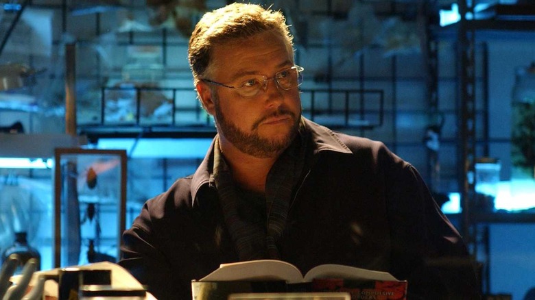 Grissom reading a book