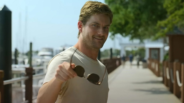 Cane smiles and takes off his sunglasses in The Waterfront