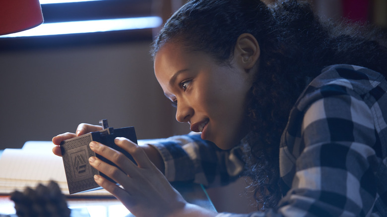 Zoey Davis trying to solve puzzle in Escape Room (2019)