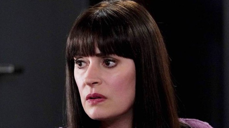 Prentiss in a dark office