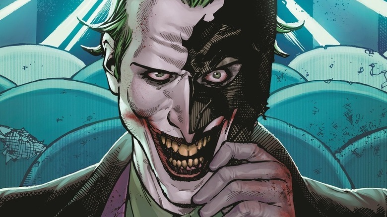 Joker holding Batman mask