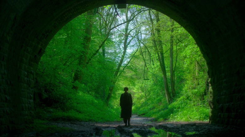Harper walking through a tunnel