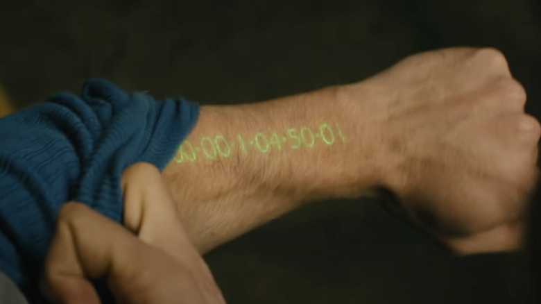 An arm illuminated with remaining time to live in 