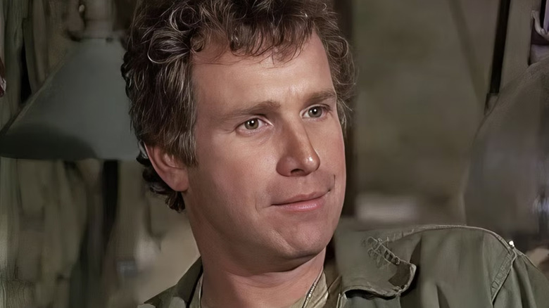 Trapper sits and smiles in "M*A*S*H" (1972)