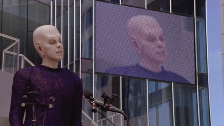 Da'an giving a speech with a big screen behind him in "Earth: Final Conflict."