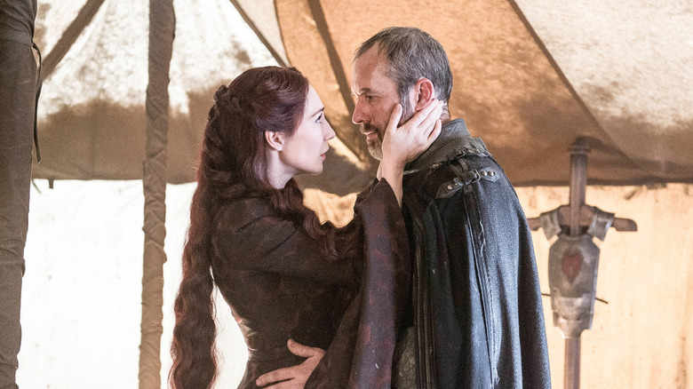 Melisandre embracing Stannis Baratheon in Game of Thrones