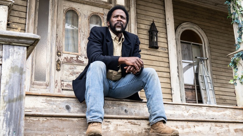 Boyd sitting on the steps in Fromville in From