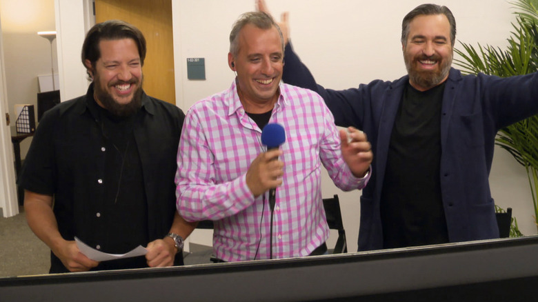 Sal, Joe, and Q watch a monitor and laugh