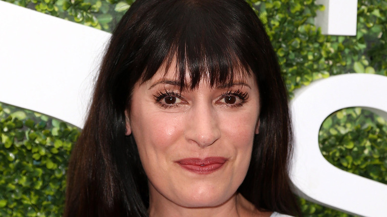 Paget Brewster smiling with bangs