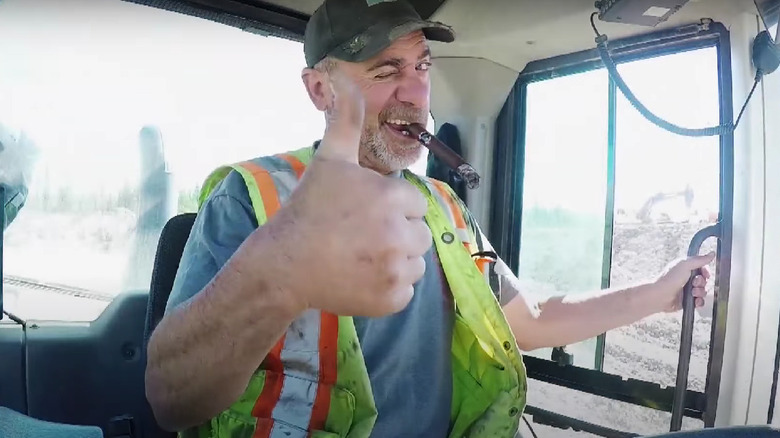 Chris Doumitt smiling and giving a thumbs up